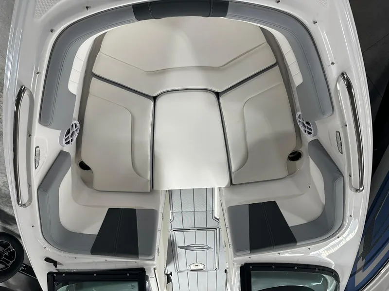 Slide: The Image of 2025 Chaparral 23 SSi boat interior with white and gray seating, top view. - 13