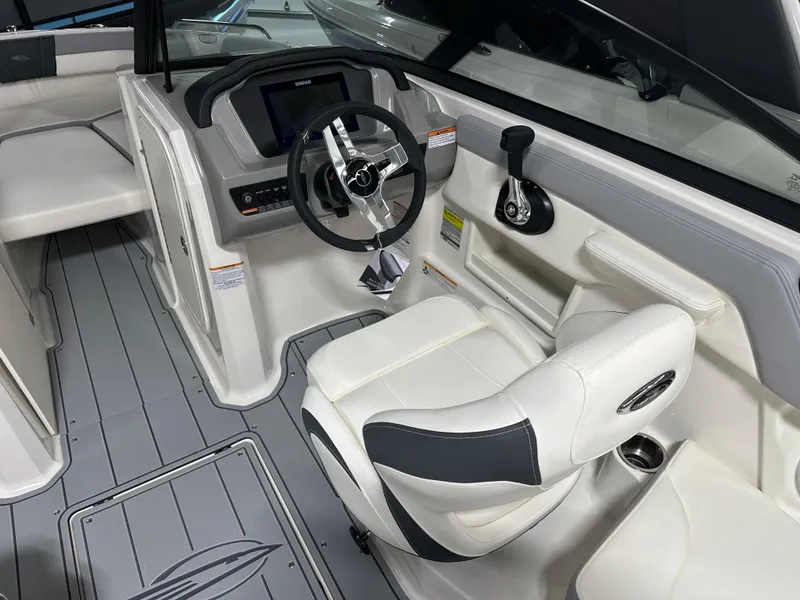 Slide: The Image of 2025 Chaparral 23 SSi boat interior with modern helm and comfortable seating. - 16