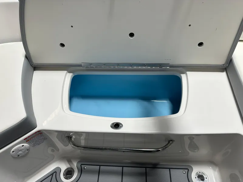 Slide: The Image of Open storage compartment in 2025 Chaparral 23 SSi boat, featuring a sleek design. - 18