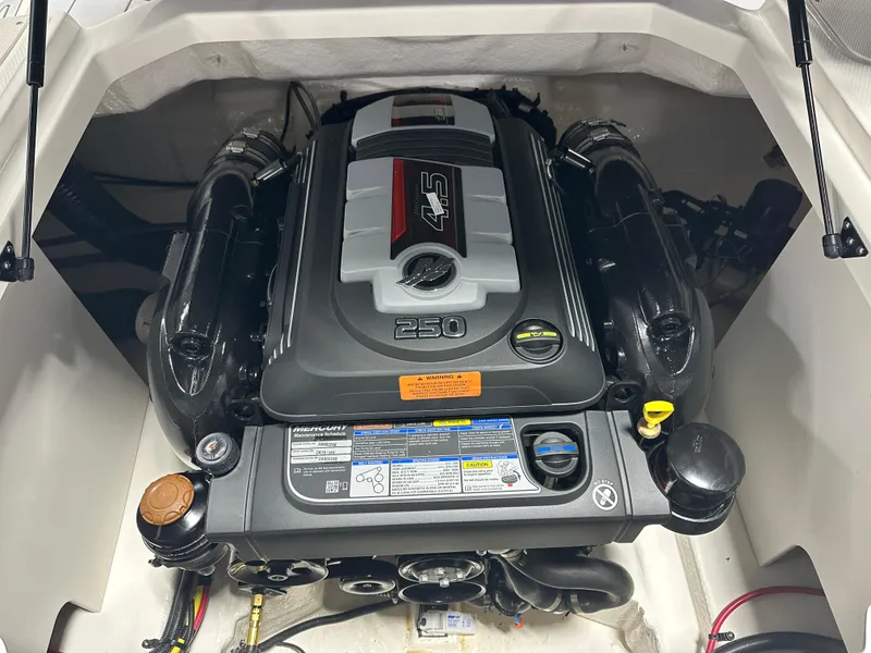 Slide: The Image of Engine compartment of a 2025 Chaparral 23 SSi boat, featuring a powerful 250 HP engine. - 19
