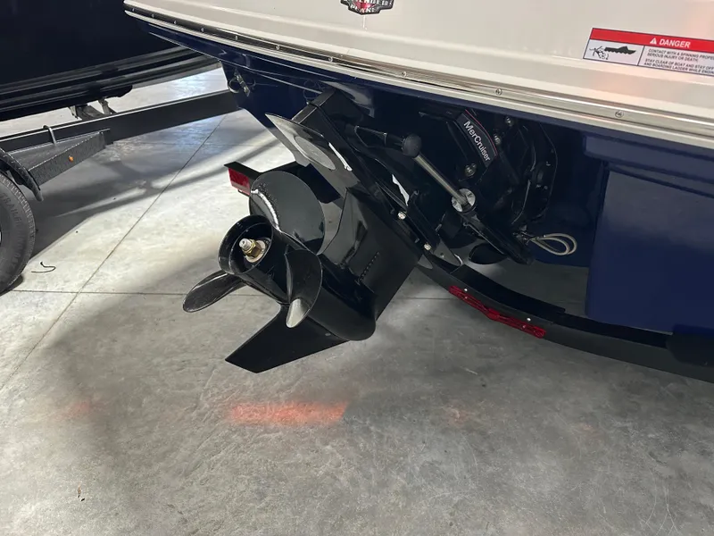 Slide: The Image of 2025 Chaparral 23 SSi boat stern with propeller and outdrive in a showroom. - 4