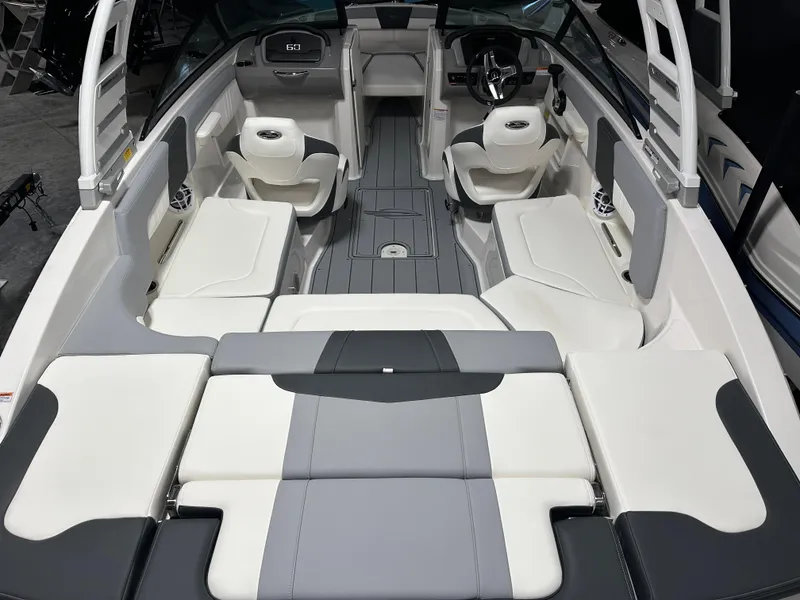 Slide: The Image of 2025 Chaparral 23 SSi boat interior with sleek seating and modern dashboard design. - 5