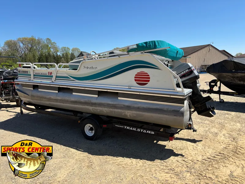 Slide: The Image of 1997 Sun Tracker BASS BUGGY 18 CC pontoon boat on a trailer at D&R Sports Center. - 2