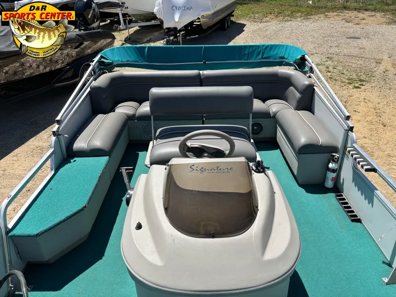 Slide: The Image of 1997 Sun Tracker BASS BUGGY 18 CC pontoon boat with teal interior and steering console. - 4