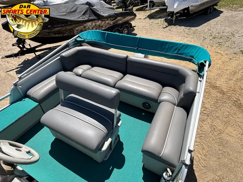 Slide: The Image of 1997 Sun Tracker BASS BUGGY 18 CC pontoon boat with gray seating and teal accents. - 6