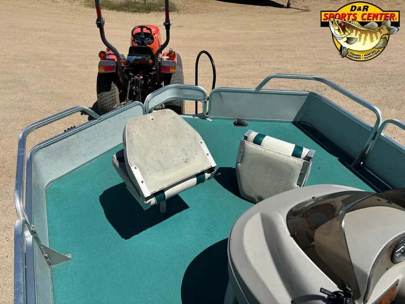 Slide: The Image of 1997 Sun Tracker BASS BUGGY 18 CC boat interior with green carpet and seating. - 7