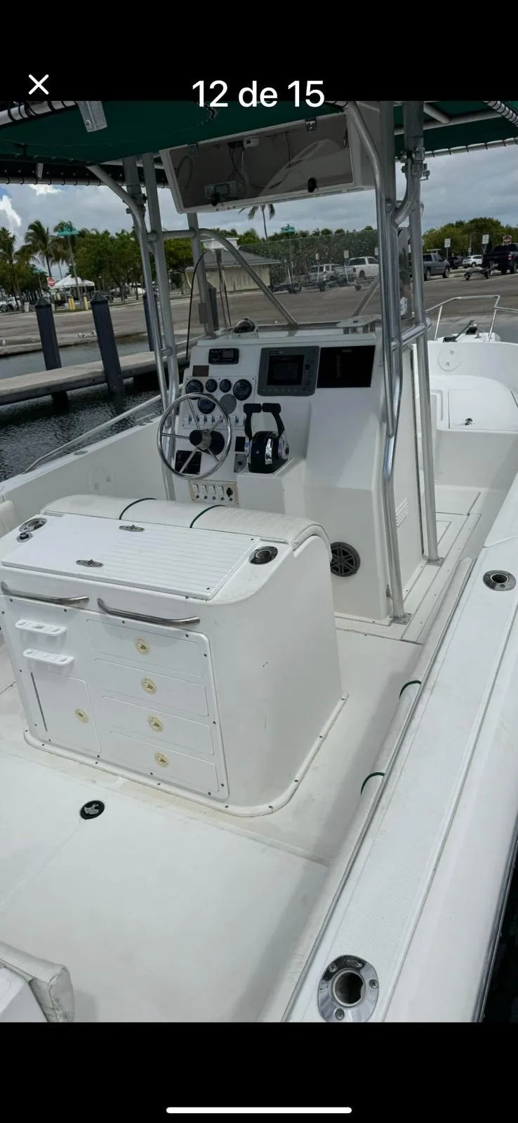 Slide: The Image of 2000 Stamas 250 Tarpon boat interior with steering console and seating at dock. - 11