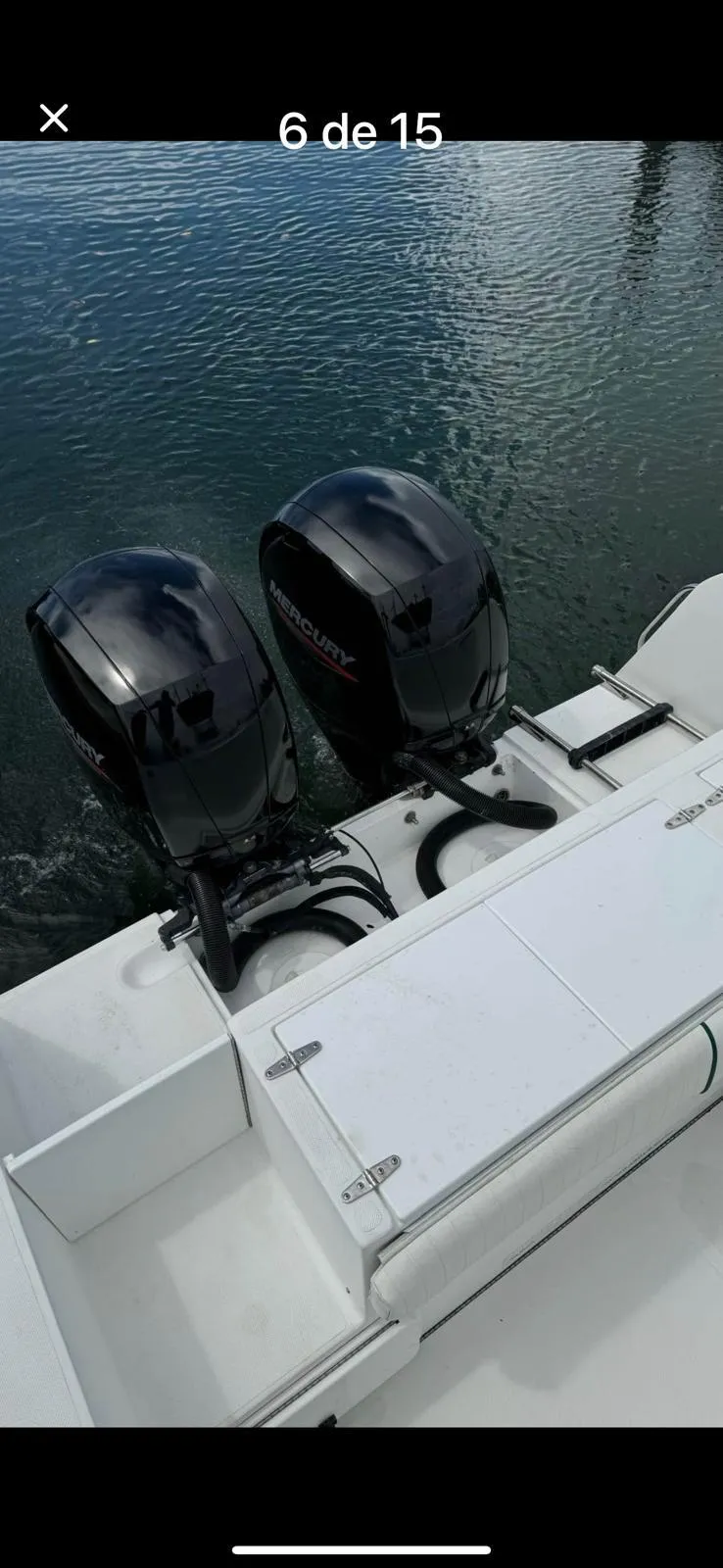 Slide: The Image of 2000 Stamas 250 Tarpon boat with dual outboard engines on calm water. - 6