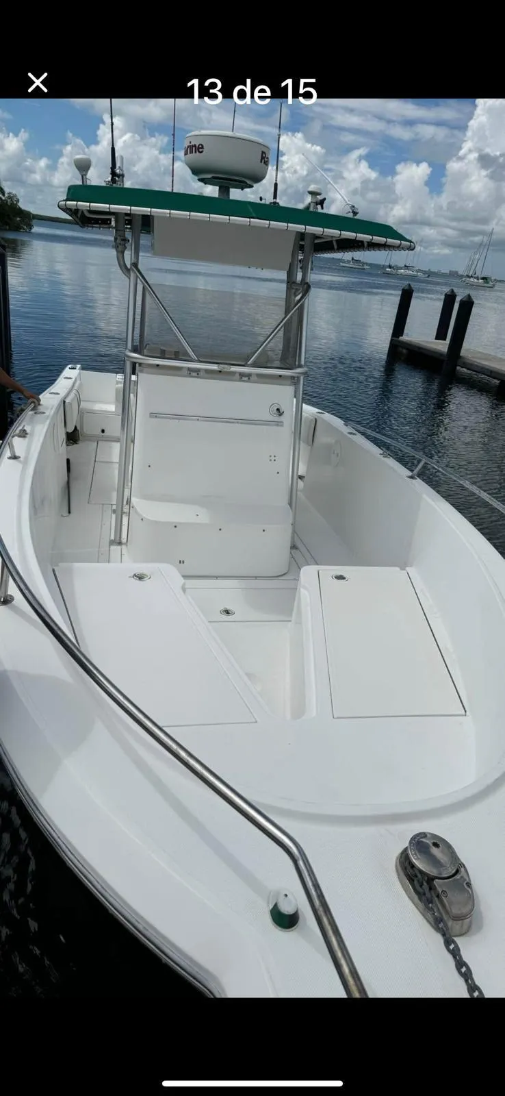 Slide: The Image of 2000 Stamas 250 Tarpon boat docked, featuring a spacious deck and T-top. - 9