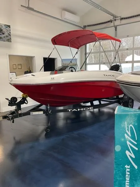 Slide: The Image of 2025 Tahoe T16 boat with red canopy in showroom. - 6