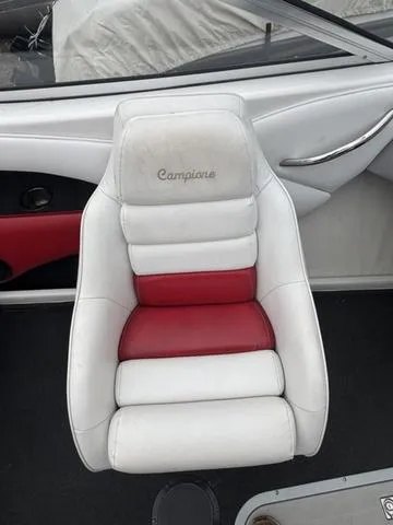 Slide: The Image of 2002 Ebbtide 210 Campione boat seat, white and red upholstery, sleek design. - 10