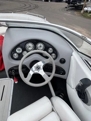 Slide: The Image of 2002 Ebbtide 210 Campione boat dashboard with steering wheel and gauges. - 13