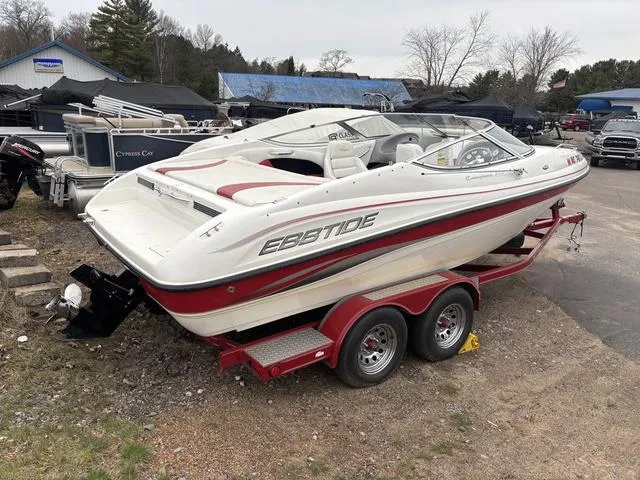 Slide: The Image of 2002 Ebbtide 210 Campione boat on red trailer, parked outdoors. - 7