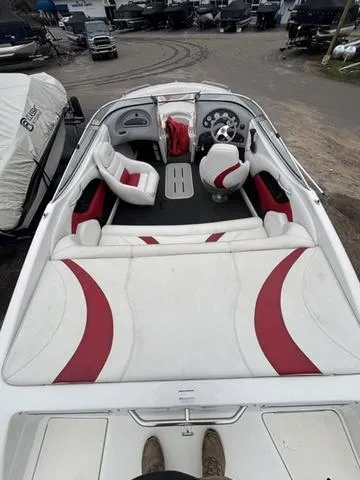 Slide: The Image of 2002 Ebbtide 210 Campione boat interior with red and white seating, steering wheel, and dashboard. - 8