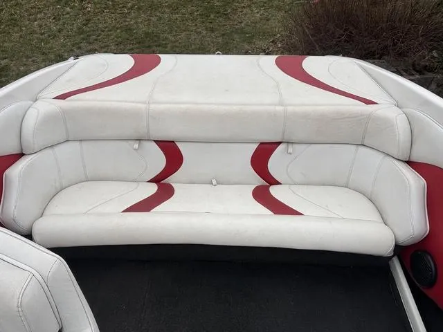 Slide: The Image of 2002 Ebbtide 210 Campione boat interior with white and red seating. - 9