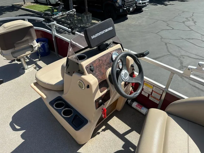 Slide: The Image of 2019 Sun Tracker Bass Buggy 18 DLX boat console with steering wheel and Humminbird display. - 18