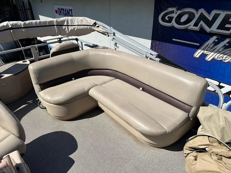 Slide: The Image of 2019 Sun Tracker Bass Buggy 18 DLX pontoon boat with beige seating and canopy. - 21