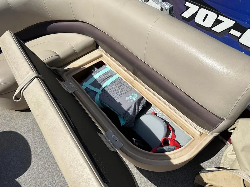 Slide: The Image of 2019 Sun Tracker Bass Buggy 18 DLX storage compartment with life jackets and gear. - 22