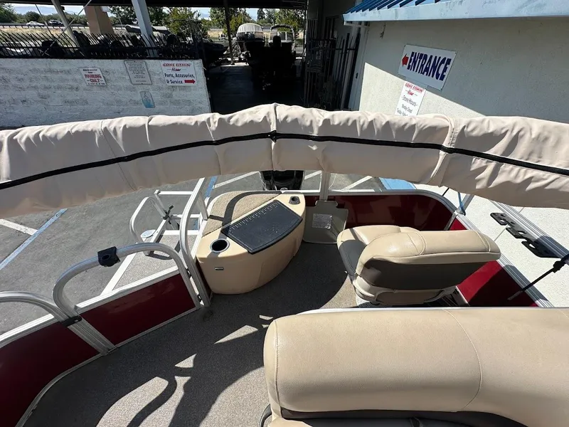 Slide: The Image of 2019 Sun Tracker Bass Buggy 18 DLX pontoon boat interior with seating and canopy. - 23