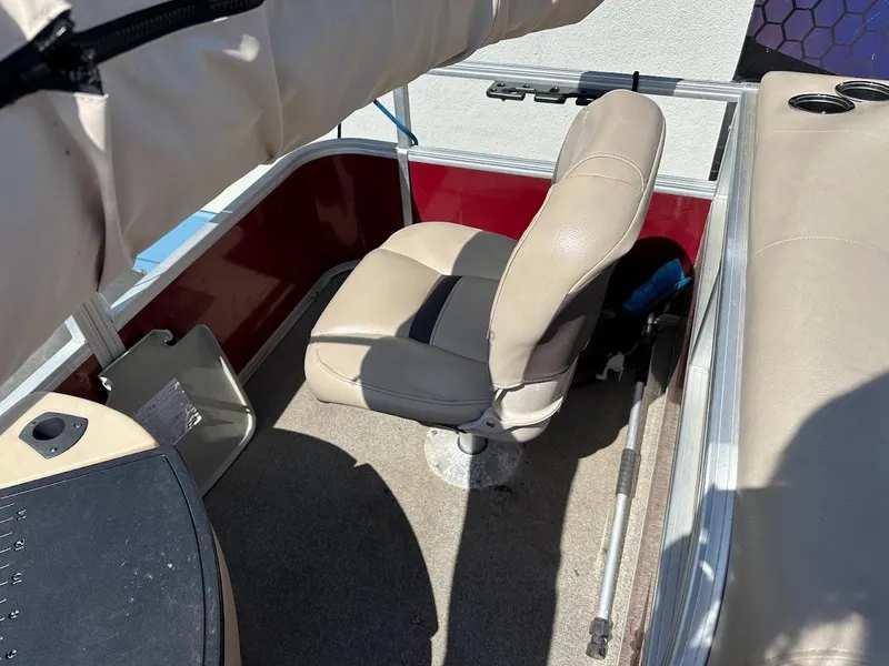 Slide: The Image of 2019 Sun Tracker Bass Buggy 18 DLX boat interior with beige seating and red accents. - 26