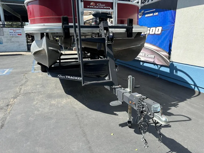 Slide: The Image of 2019 Sun Tracker Bass Buggy 18 DLX pontoon boat on trailer in parking lot. - 3