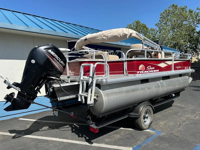 Slide: The Image of 2019 Sun Tracker Bass Buggy 18 DLX pontoon boat with Mercury engine on trailer. - 6