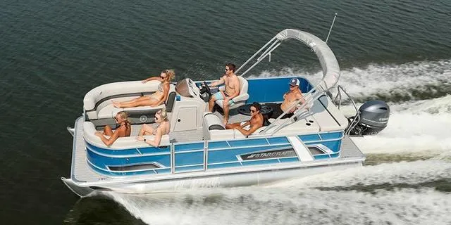 Slide: The Image of 2025 Starcraft EX20R pontoon boat cruising with passengers on a sunny day. - 1