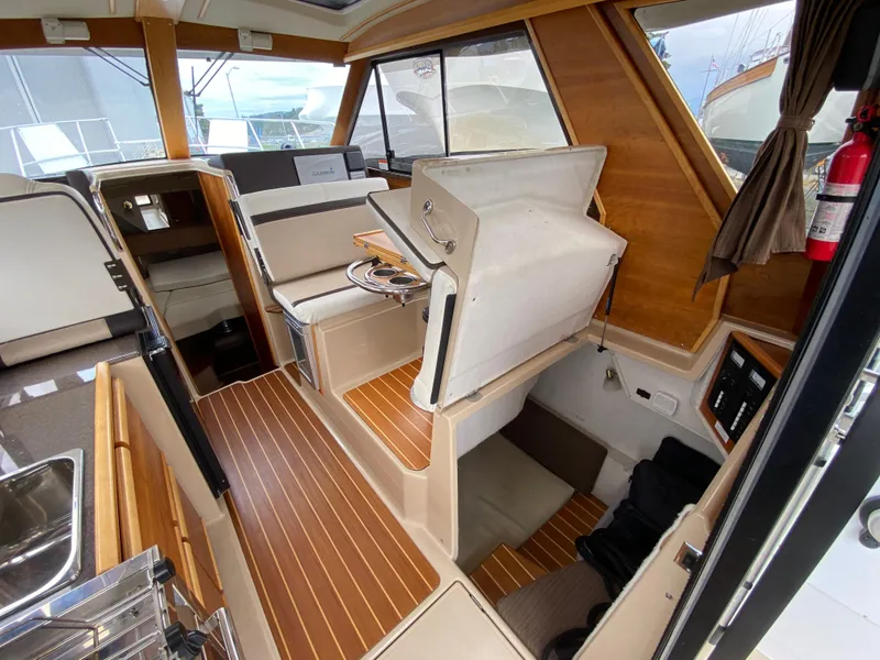 Slide: The Image of Interior of a 2017 Cutwater C-28 boat with wood accents and seating area. - 18