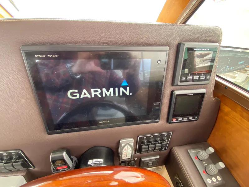 Slide: The Image of Garmin navigation system on 2017 Cutwater C-28 boat dashboard with control panels. - 24