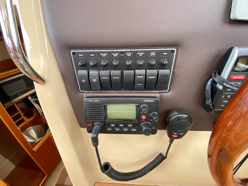 Slide: The Image of Control panel of a 2017 Cutwater C-28 boat with radio and switches. - 26
