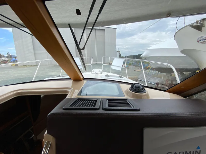 Slide: The Image of 2017 Cutwater C-28 boat interior with dashboard view, featuring navigation equipment and windshield. - 29