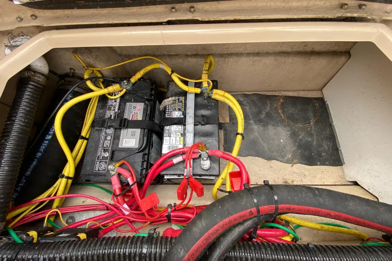 Slide: The Image of Battery compartment of a 2017 Cutwater C-28 boat with wiring and connections. - 44
