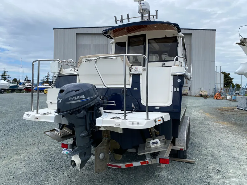 Slide: The Image of 2017 Cutwater C-28 boat with Yamaha outboard motor on trailer, parked near a large building. - 47