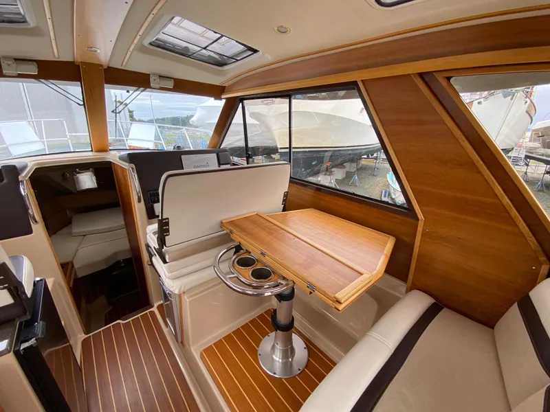 Slide: The Image of 2017 Cutwater C-28 interior with wood accents, seating, and foldable table. - 5