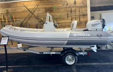 Slide: The Image of 2025 Inmar 430R-AL inflatable boat on trailer, displayed indoors with wooden wall backdrop. - 1