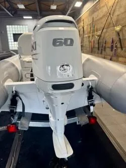 Slide: The Image of 2025 Inmar 430R-AL boat with 60 HP outboard motor in a showroom. - 10