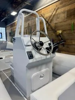 Slide: The Image of 2025 Inmar 430R-AL boat console with steering wheel, modern design, and wooden wall backdrop. - 2