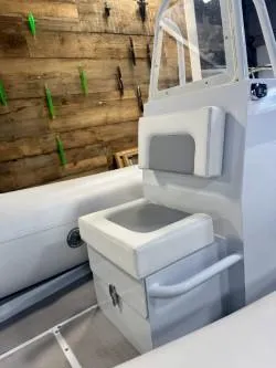 Slide: The Image of 2025 Inmar 430R-AL boat interior with white seating and wooden wall background. - 7