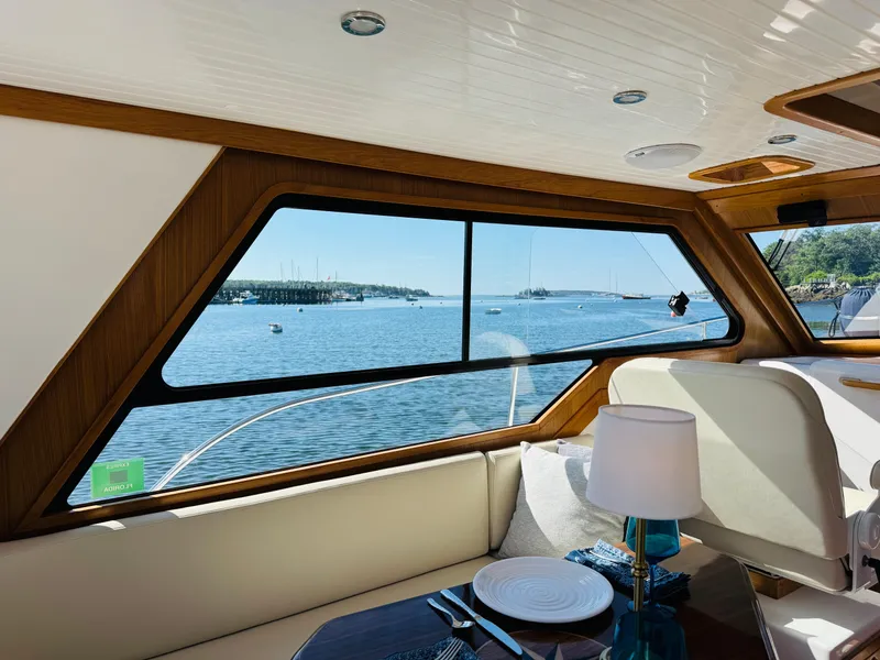 Slide: The Image of Interior view of 2024 True North 34 Outboard Express yacht with scenic ocean backdrop. - 11