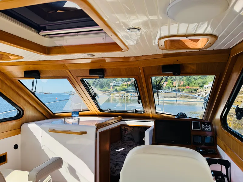Slide: The Image of Interior of 2024 True North 34 Outboard Express boat with scenic water view. - 12