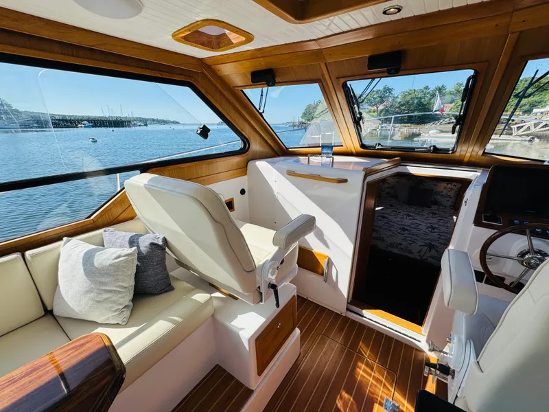 Slide: The Image of Luxurious interior of 2024 True North 34 Outboard Express yacht with scenic water views. - 14