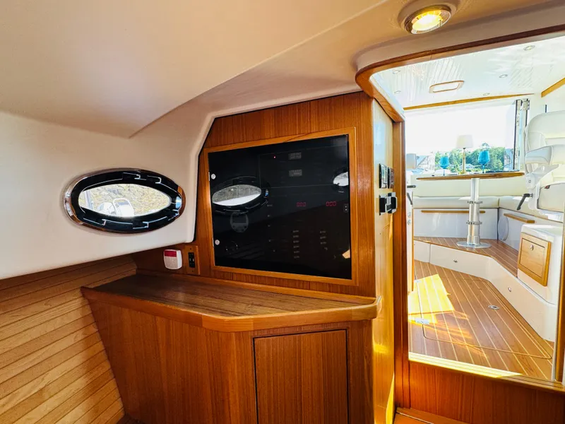 Slide: The Image of Interior of 2024 True North 34 Outboard Express, featuring wood paneling and modern design. - 29