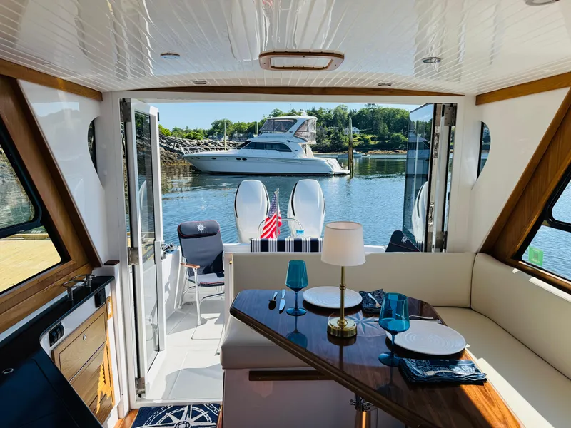 Slide: The Image of Interior of 2024 True North 34 Outboard Express yacht with elegant dining setup. - 3