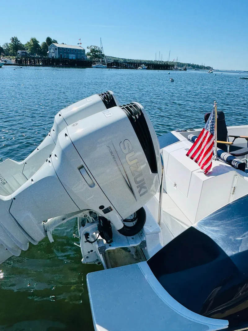 Slide: The Image of 2024 True North 34 Outboard Express with Suzuki engines, American flag, docked on a sunny day. - 31