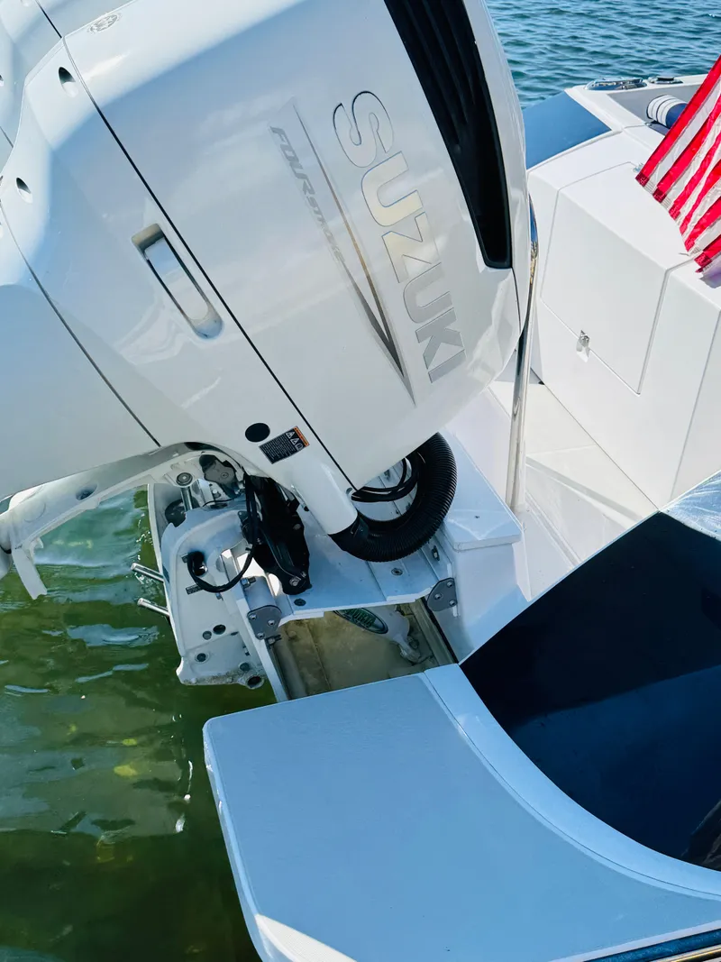 Slide: The Image of 2024 True North 34 Outboard Express with Suzuki engine, docked on water. - 32