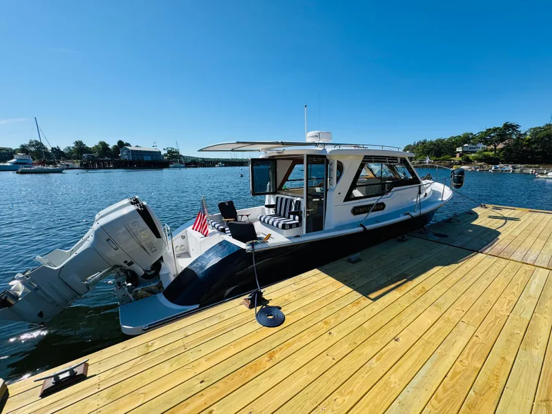 Slide: The Image of 2024 True North 34 Outboard Express docked on a sunny day. - 36