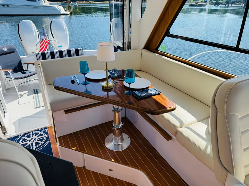 Slide: The Image of Luxurious interior of 2024 True North 34 Outboard Express yacht with elegant dining setup. - 4