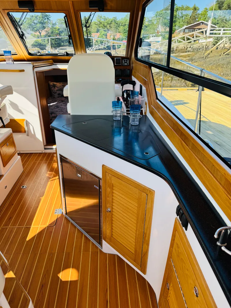 Slide: The Image of Interior of 2024 True North 34 Outboard Express with wood accents and modern amenities. - 6
