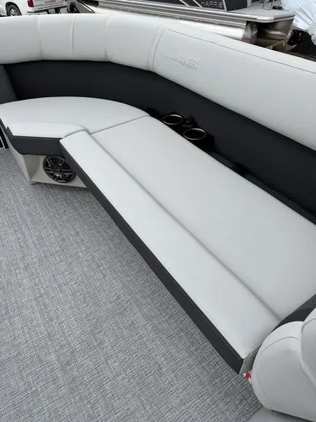 Slide: The Image of 2025 Harris Cruiser 230 boat interior with gray seating and cup holders. - 6