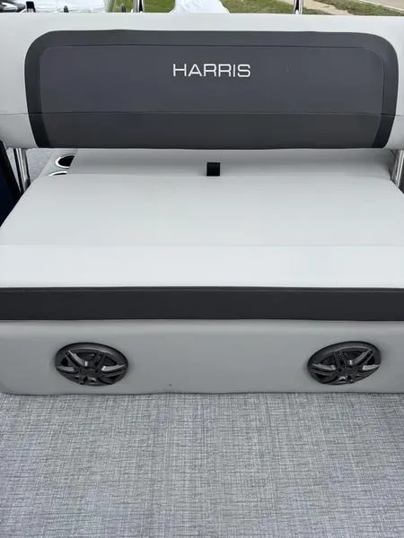 Slide: The Image of 2025 Harris Cruiser 230 boat seat with speakers, featuring sleek gray upholstery. - 7